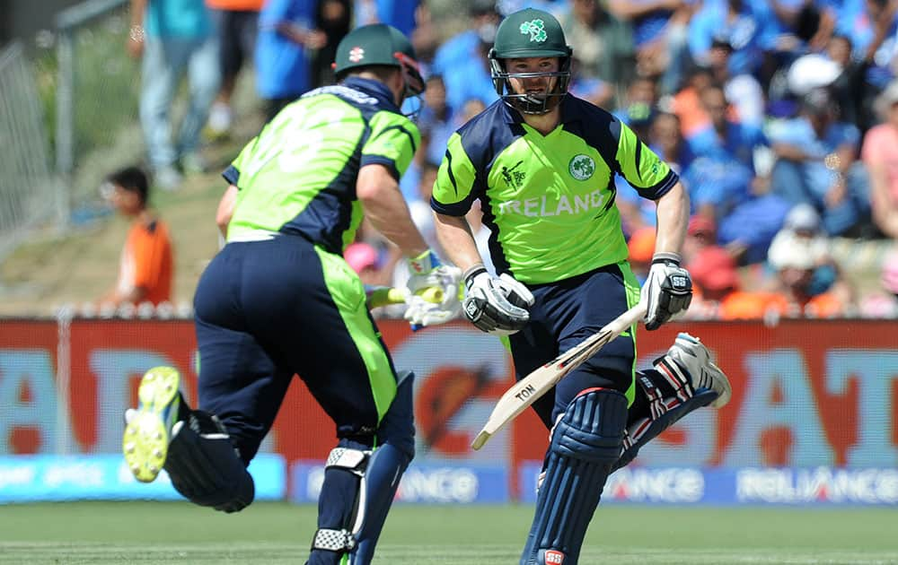 Ireland's Paul Stirling, right, and teammate William Portfield run between the wickets during their Cricket World Cup Pool B match against India in Hamilton, New Zealand.