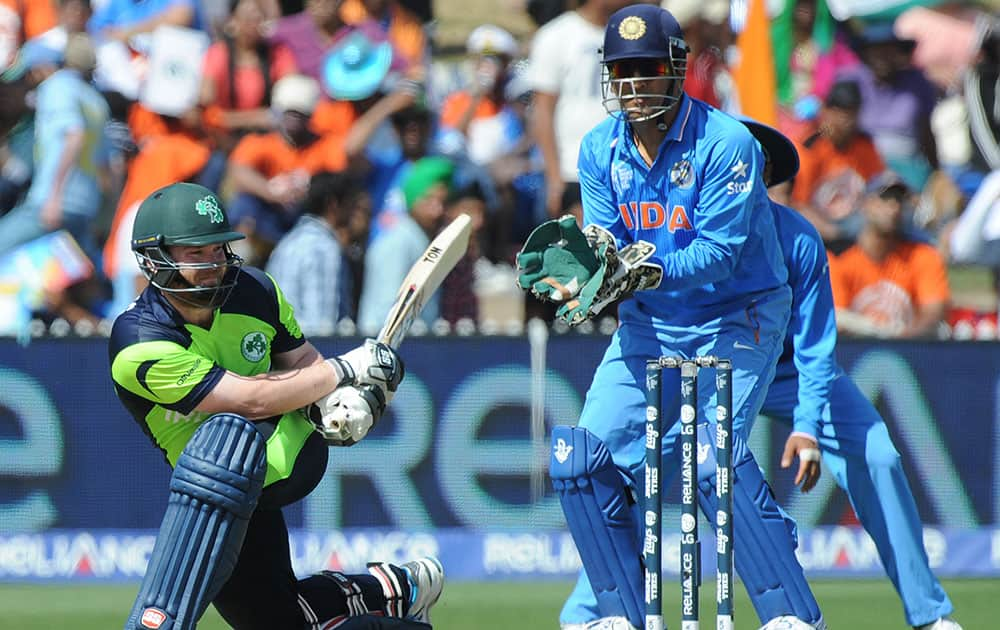 Ireland's Paul Stirling plays a sweep shot as India's wicketkeeper MS Dhoni watches during their Cricket World Cup Pool B match in Hamilton, New Zealand.