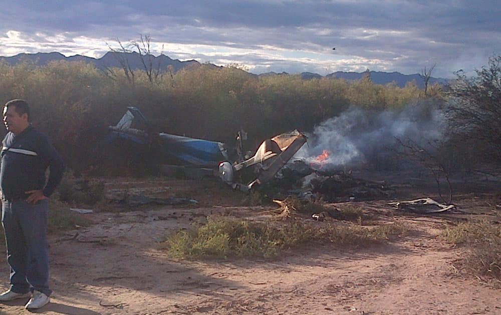A man stands near one of two helicopters that crashed near Villa Castelli in the La Rioja province of Argentina.