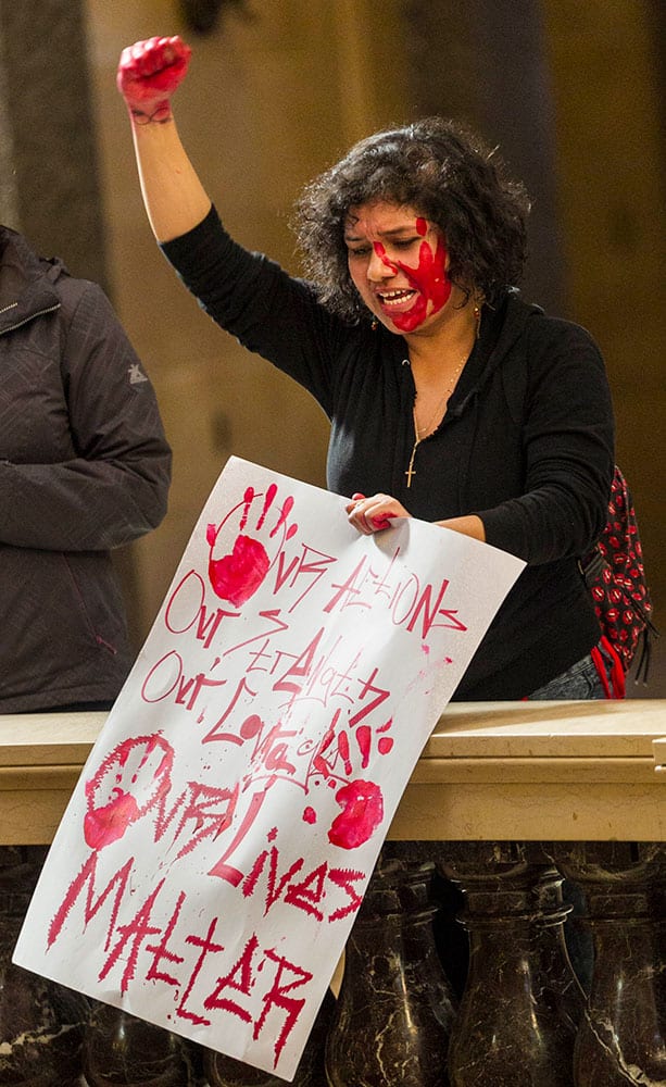 Angelica Alv protests the shooting of Tony Robinson at the state Capitol, in Madison, Wis.