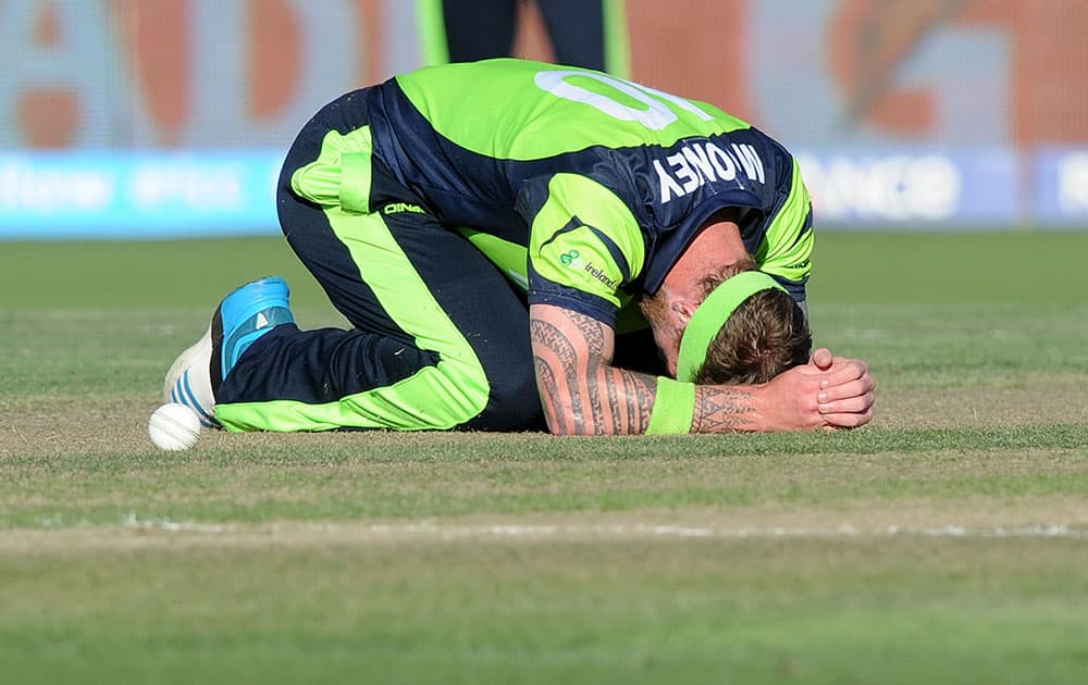 Ireland's John Mooney rests on the ground after he missed a catch chance during their Cricket World Cup Pool B match against India in Hamilton, New Zealand.