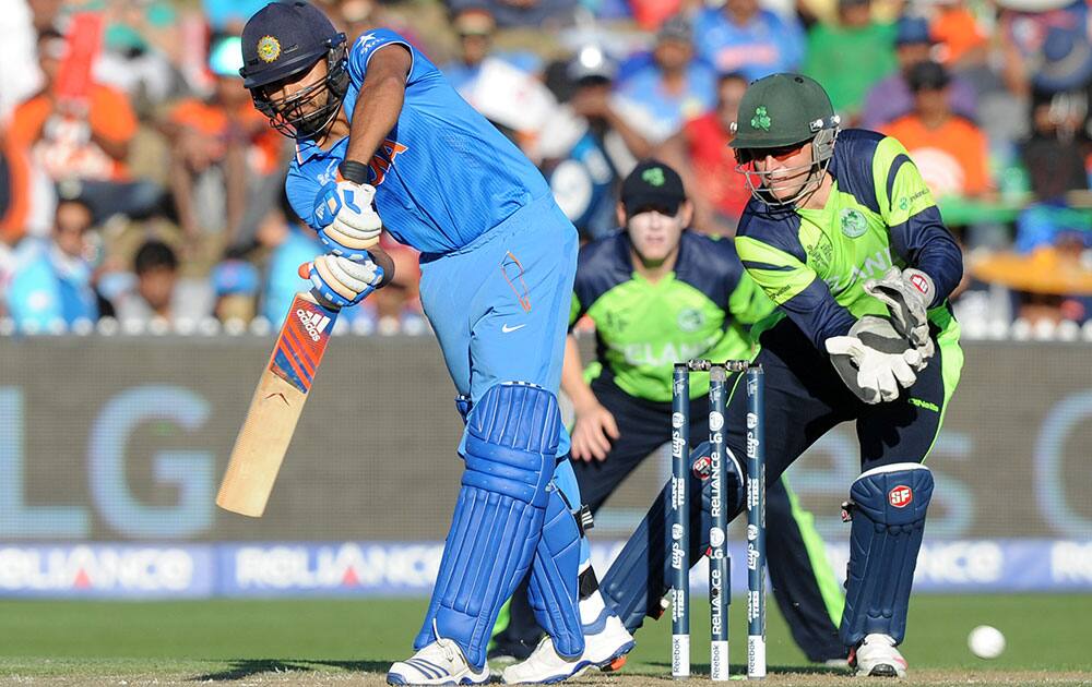 Indian batsman Rohit Sharma plays a shot as Ireland's wicketkeeper Gary Wilson watches during their Cricket World Cup Pool B match in Hamilton, New Zealand.