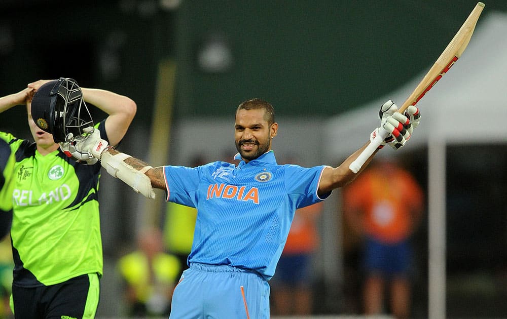 India's Shikhar Dhawan celebrates after scoring a century while batting against Ireland during their Cricket World Cup Pool B match in Hamilton, New Zealand.