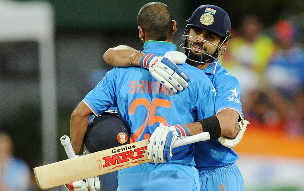 India's Virat Kohli, right, congratulates teammate Shikhar Dhawan after scoring a century while batting against Ireland during their Cricket World Cup Pool B match in Hamilton, New Zealand.