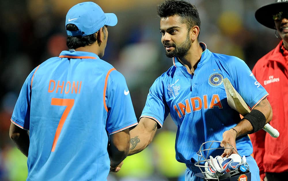 India's Virat Kohli, right, is congratulated by his captain MS Dhoni after they defeated Ireland by eight wickets in their Cricket World Cup Pool B match in Hamilton, New Zealand.