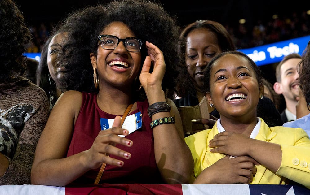 Young women react as President Barack Obama begins to speak at Georgia Tech in Atlanta,, about his plan to clamp down on the private companies that service federal student debt. 