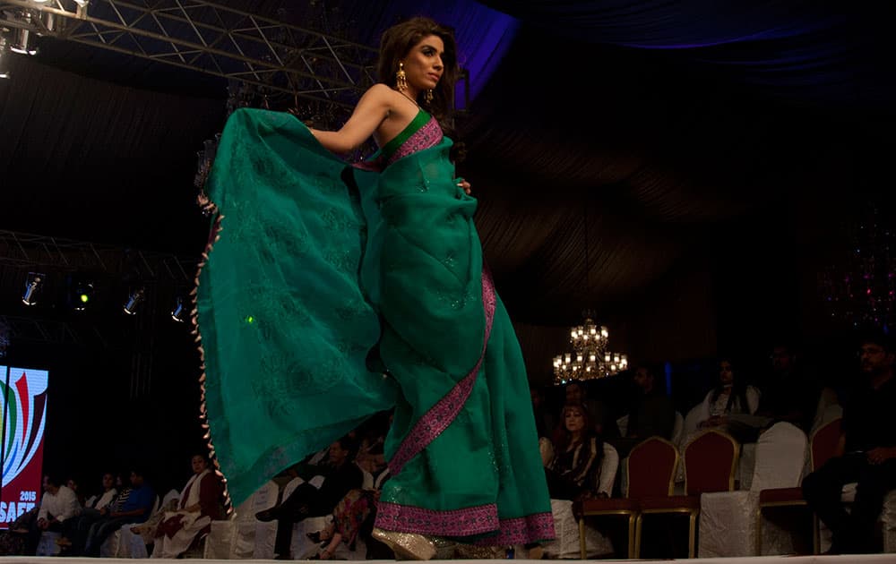 A model presents creations by Bangladeshi designer Maheen Khan at South Asian Fashion Exhibition 2015 , in Karachi, Pakistan. 