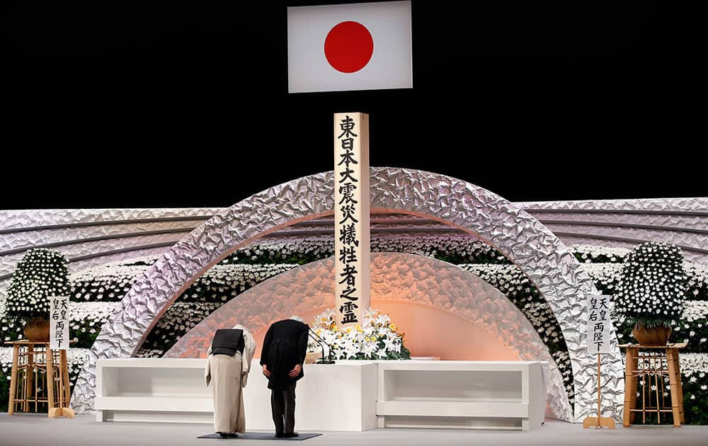 Japan's Emperor Akihito and Empress Michiko bow in front of the altar for the victims of the March 11, 2011 earthquake and tsunami, at the national memorial service in Tokyo.