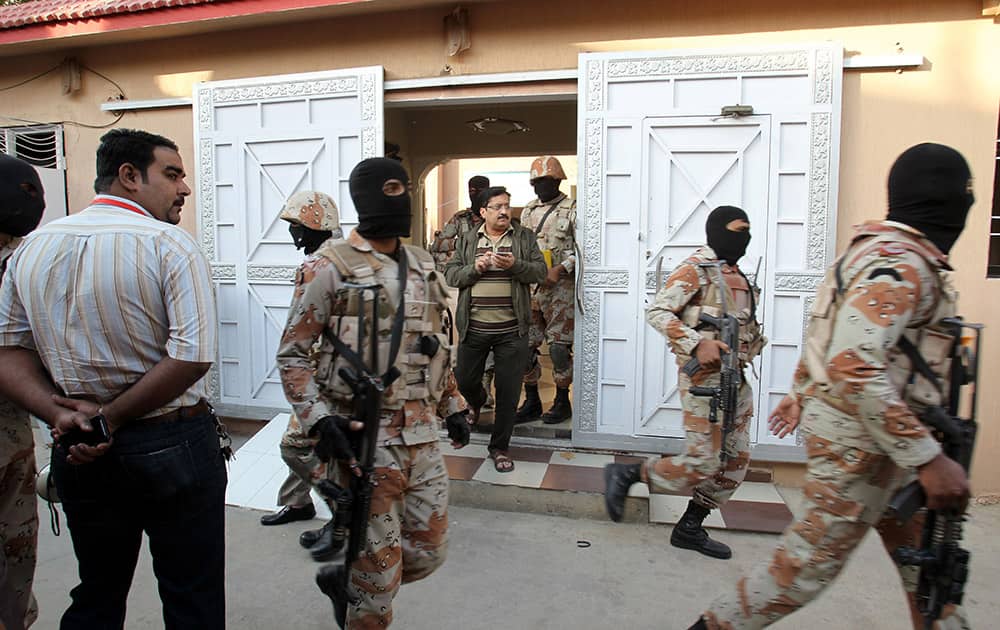 Pakistani paramilitary troops raid the Muttahida Quami Movement's offices in Karachi, Pakistan. A Pakistani army officer says about 20 suspects were arrested, weapons seized and the premises were sealed during a raid on the headquarters of the well-known political party.