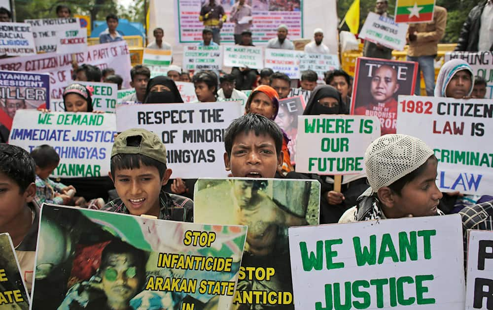 Rohingya refugees living in India hold placards during a protest demanding an end to the violence against ethnic Rohingyas in Rakhine State of Myanmar, in New Delhi.