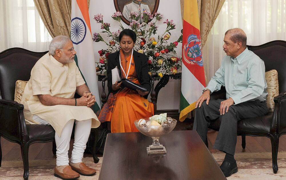 Prime Minister Narendra Modi, listens to Seychelles President James Michel during a meeting in Mahe, Seychelles.