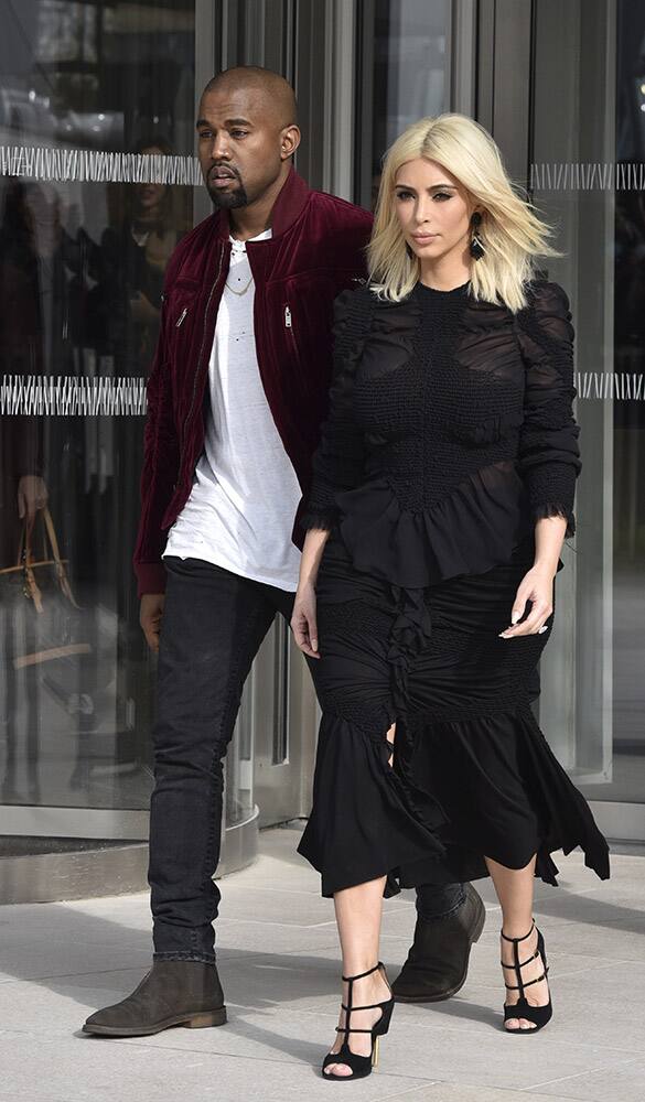 Kim Kardashian and singer Kanye West leave Louis Vuitton's Fall-Winter ready-to-wear fashion collection presented during the Paris Fashion Week.