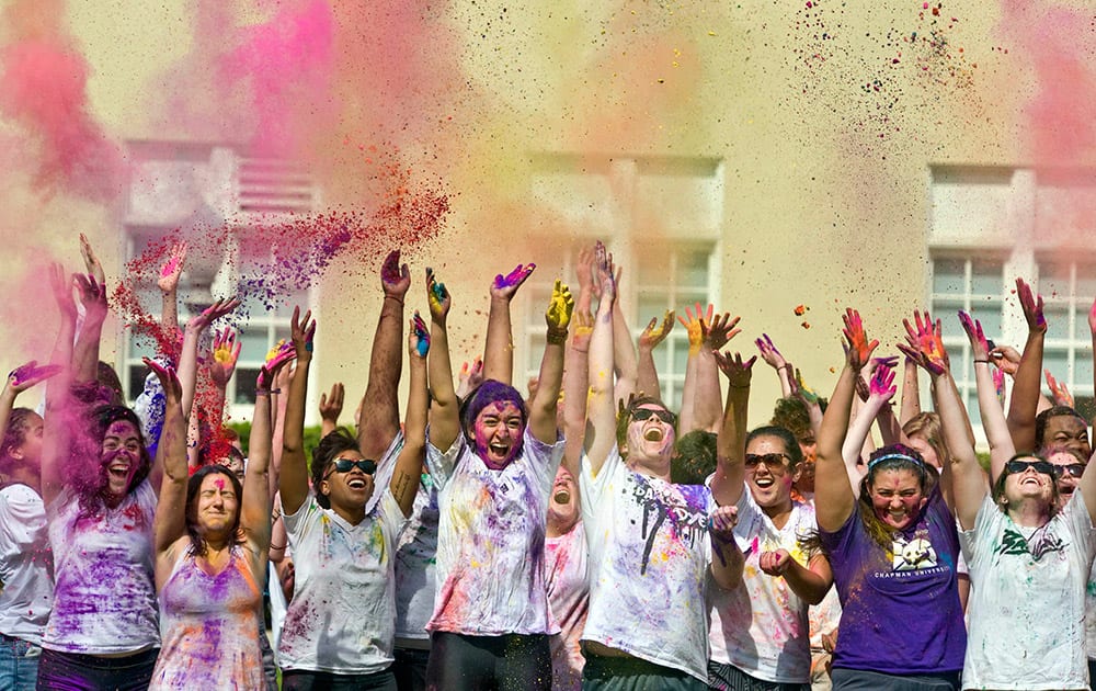 Chapman University students celebrate the Hindu festival of Holi, known for its use of colorful powder in celebrations, on the campus' Bert Williams lawn.