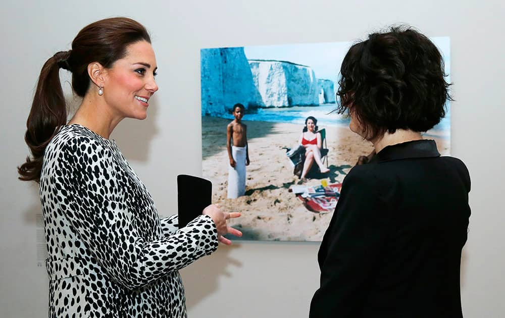 Kate, the Duchess of Cambridge, left, talks with artist Trish Morrissey about her photograph 