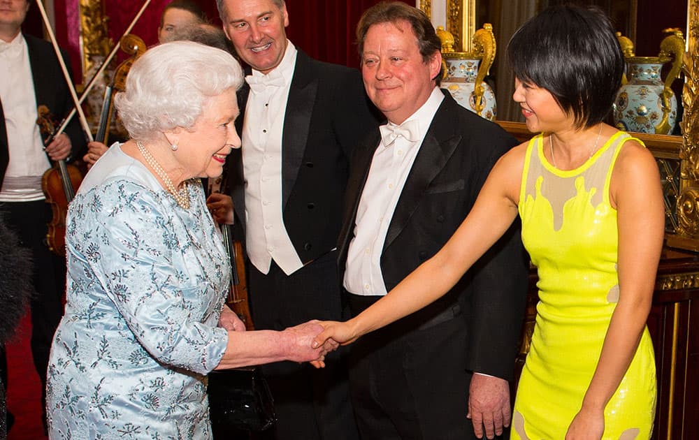 Britain's Queen Elizabeth II greets pianist Yuja Wang during a reception at Buckingham Palace to mark the conclusion of the 