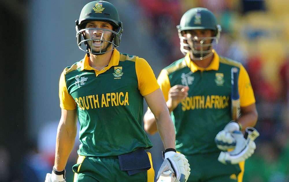 South Africa's Farhaan Behardien, left, and teammate Vernon Philander walk from the field after scoring 341 runs against the United Arab Emirates during their Cricket World Cup Pool B match in Wellington, New Zealand.