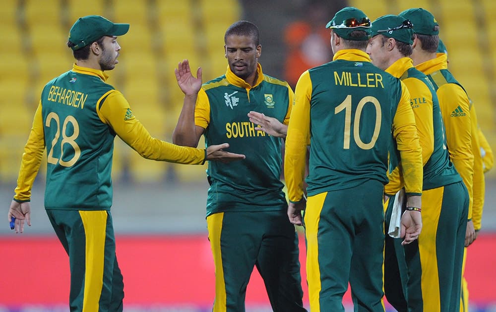 South Africa's Vernon Philander, is congratulated by teammates after he took the wicket of United Arab Emirates batsman Muhammad Naveed during their Cricket World Cup Pool B match in Wellington, New Zealand.