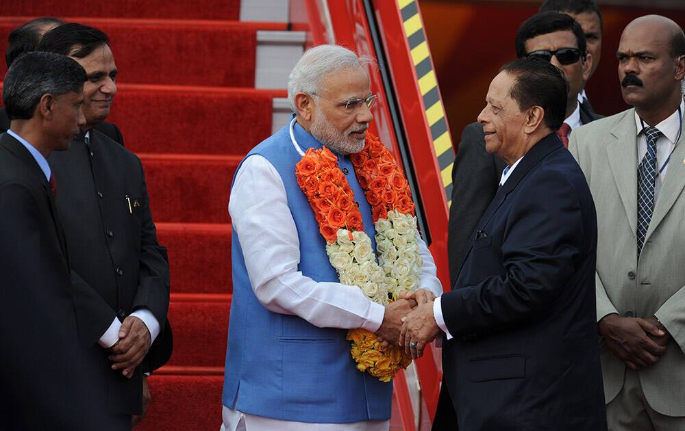 Prime Minister Narendra Modi, is greeted by Prime Minister of Mauritius Anerood Jugnauth, center-right, upon his arrival at the airport on Mauritius Island, in the Republic of Mauritius.