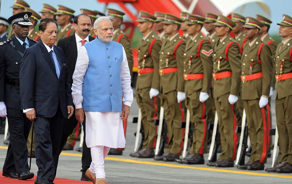 Prime Minister Narendra Modi, inspects an honour guard accompanied by Prime Minister of Mauritius Anerood Jugnauth, upon his arrival at the airport on Mauritius Island, in the Republic of Mauritius.