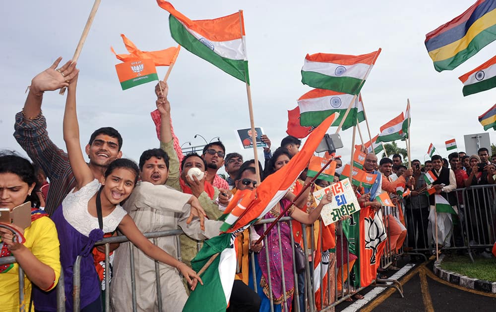 Crowds gather to see Prime Minister Narendra Modi upon his arrival at the airport on Mauritius Island, in the Republic of Mauritius.