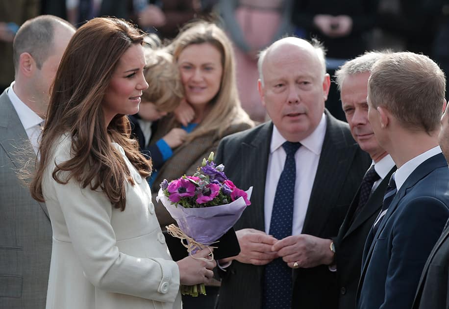 Britain's Duchess of Cambridge, meets with Ealing Studios employees as she arrives for a visit at the the set of TV series Downton Abbey, in west London. Kate, The Duchess of Cambridge, who is due to give birth in April, is touring behind the scenes at the famous Ealing Studios to meet with staff of TV drama Downton Abbey.