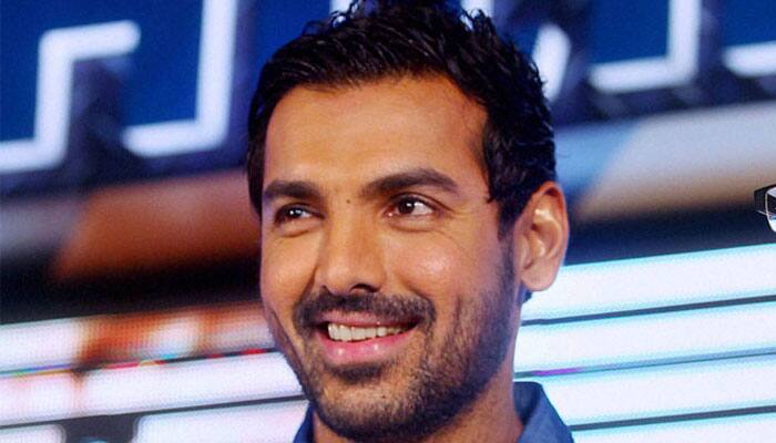 Who helped John Abraham improve his comic timing?