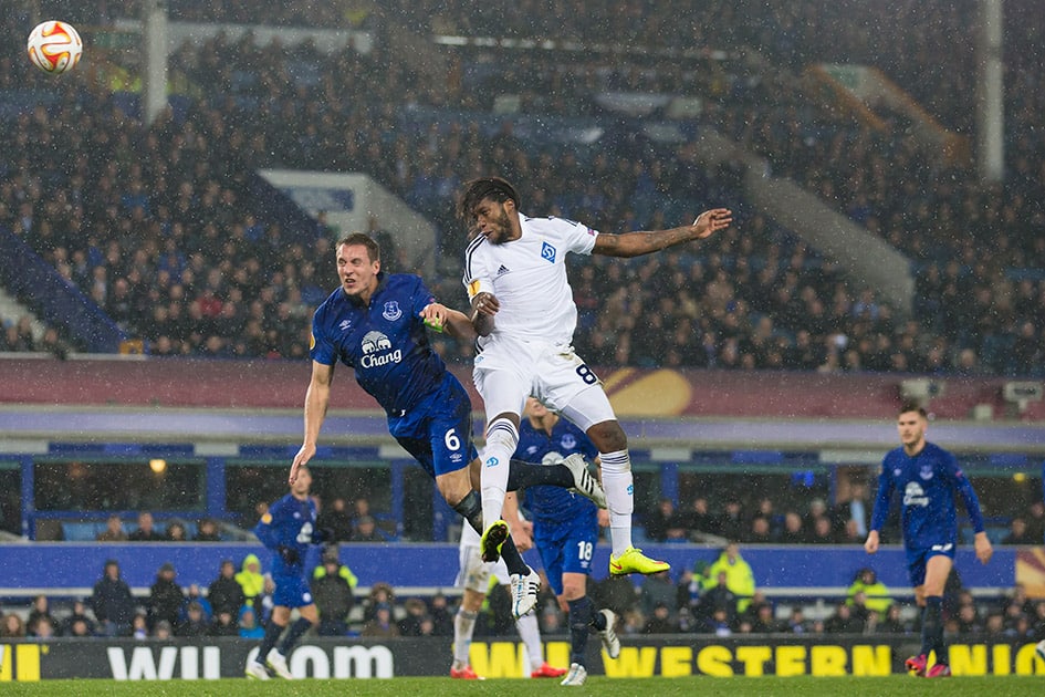 Everton's Philip Jagielka, fights for the ball against Dynamo Kiev's Dieumerci Mbokani during the Europa League round of 16 first leg soccer match between Everton and Dynamo Kiev at Goodison Park Stadium, Liverpool, England.