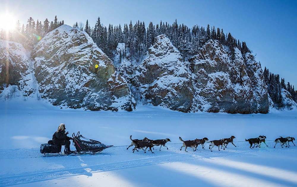 Mike Santos mushes past cliffs on the Yukon River outside Ruby, Alaska.