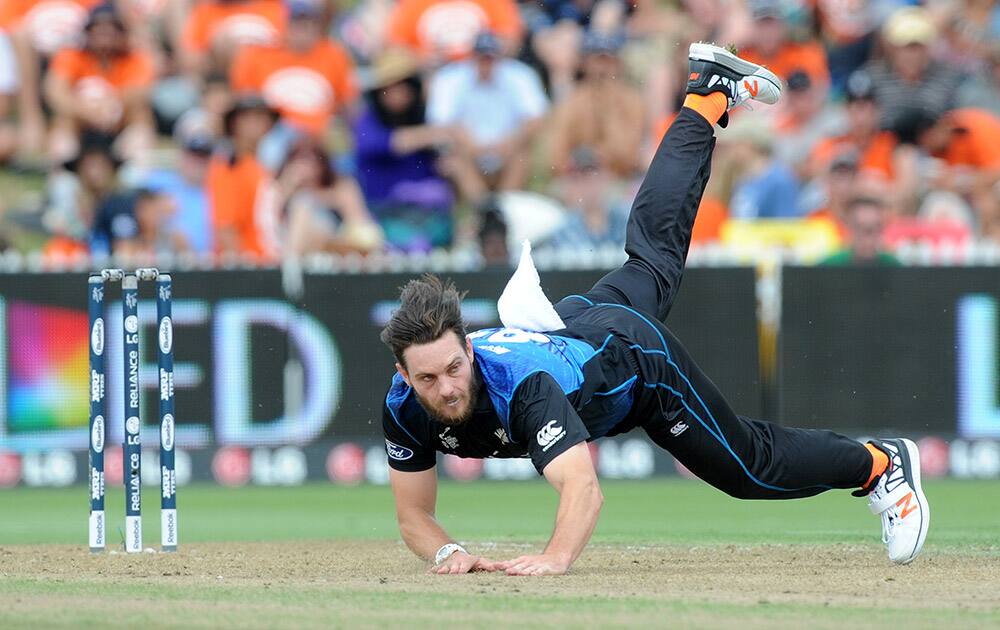 New Zealand's Mitchell McClenaghan falls while bowling during their Cricket World Cup Pool A match against Bangladesh in Hamilton, New Zealand.