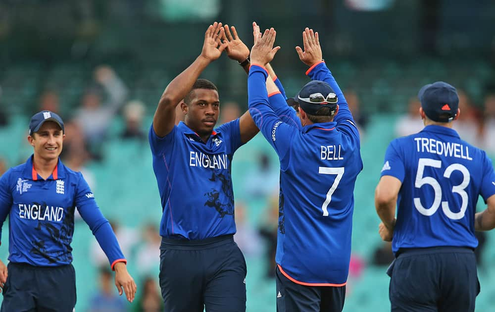 England's Chris Jordan, second left, celebrates with teammates after dismissing Afghanistan’s Afsar Zazai during their Cricket World Cup pool A match in Sydney.