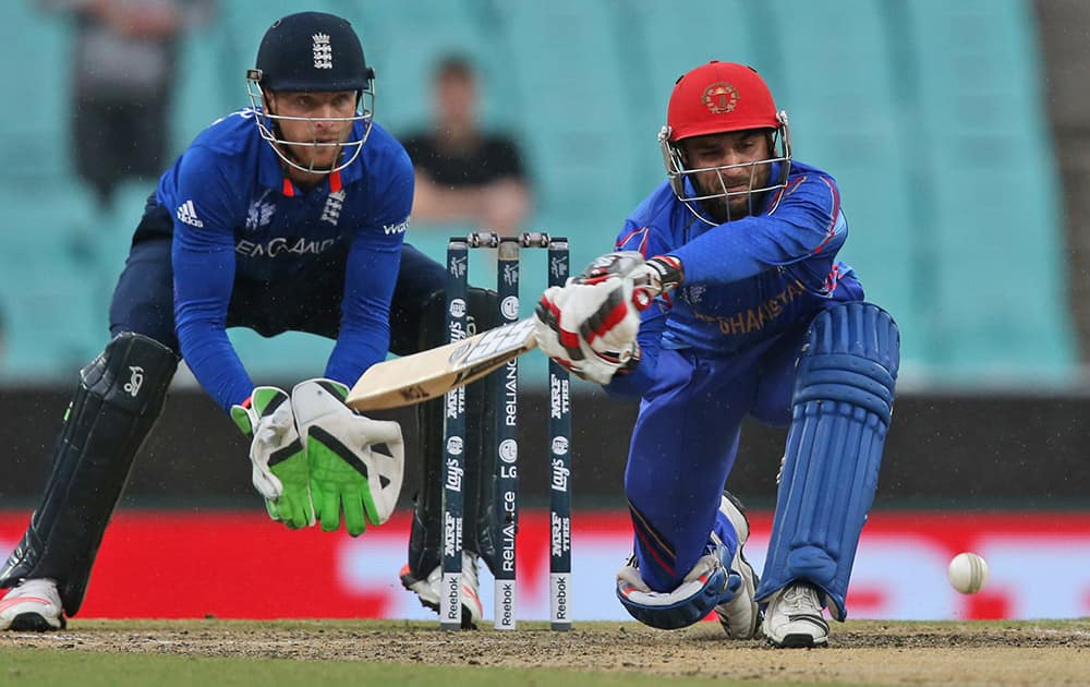 Afghanistan's Shafiqullah bats as England's Jos Buttler cups his hands to receive the ball during their Cricket World Cup pool A match in Sydney