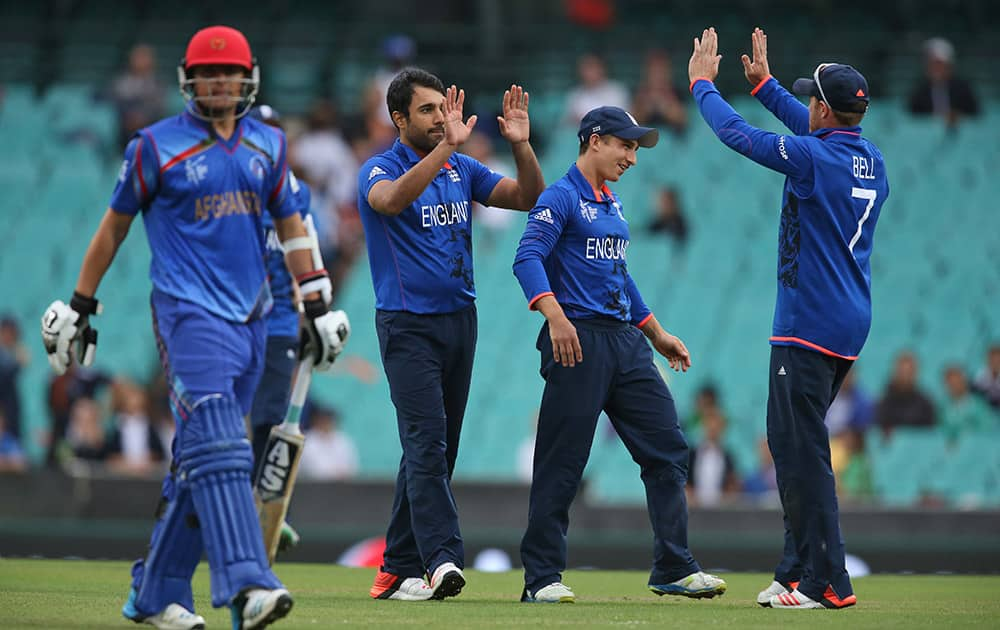 England's Ravi Bopara, celebrates with teammates after dismissing Afghanistan’s Jamal Nasir, left, during their Cricket World Cup pool A match in Sydney.