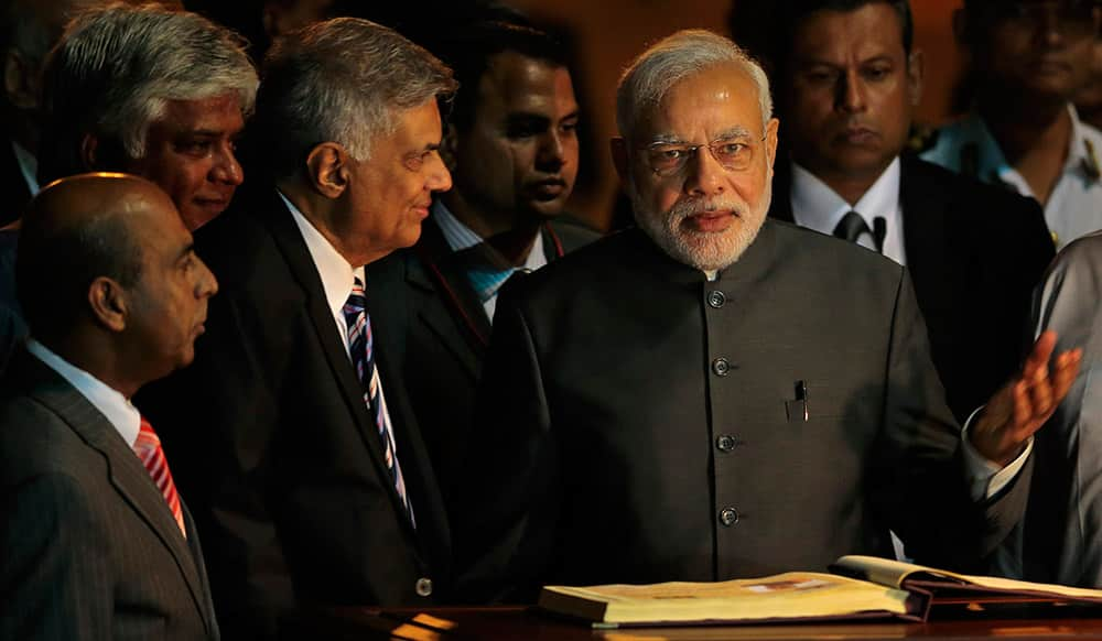 PM Narendra Modi, gestures after signing the visitor's book upon his arrival in Colombo, Sri Lanka.