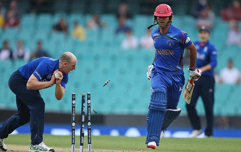 Afghanistan’s Zadran Najibullah completes a run as England's James Tredwell knocks the stumps to attempt a run-out during their Cricket World Cup pool A match in Sydney.