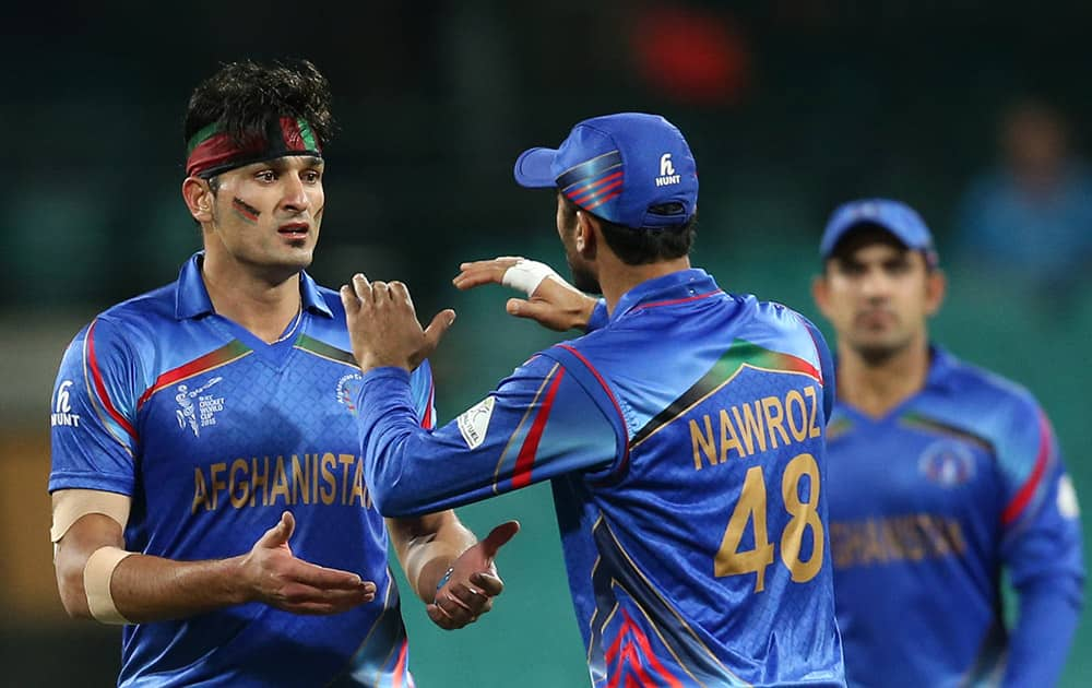 Afghanistan’s Hassan Hamid, celebrates with teammates the dismissal of England's Alex Hales during their Cricket World Cup pool A match in Sydney, Australia.