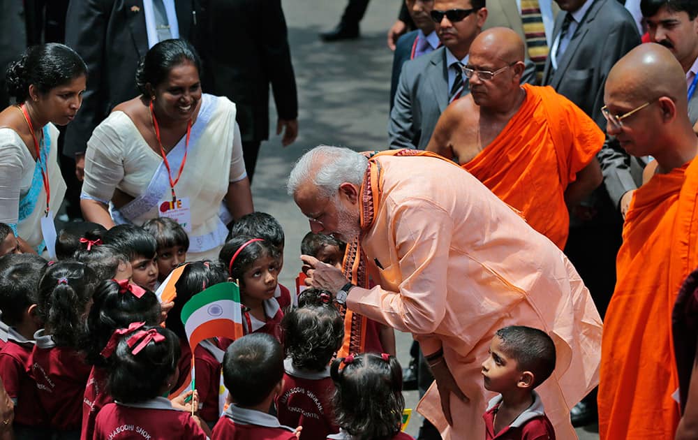 Prime Minister Narendra Modi interacts with school children during his visit to the Maha Bodhi Buddhist temple in Colombo, Sri Lanka.