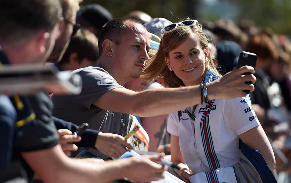 Williams Formula One test driver Susie Wolff of Britain has a selfie photo taken with a fan as she arrives at Albert Park circuit ahead of the Australian Formula One Grand Prix in Melbourne, Australia.