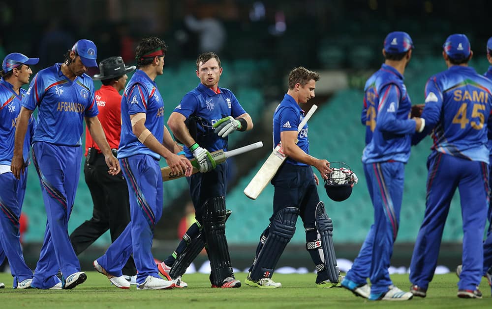 Afghanistan’s Hassan Hamid walks with England's Ian Bell at the end of their Cricket World Cup pool A match in Sydney, Australia.