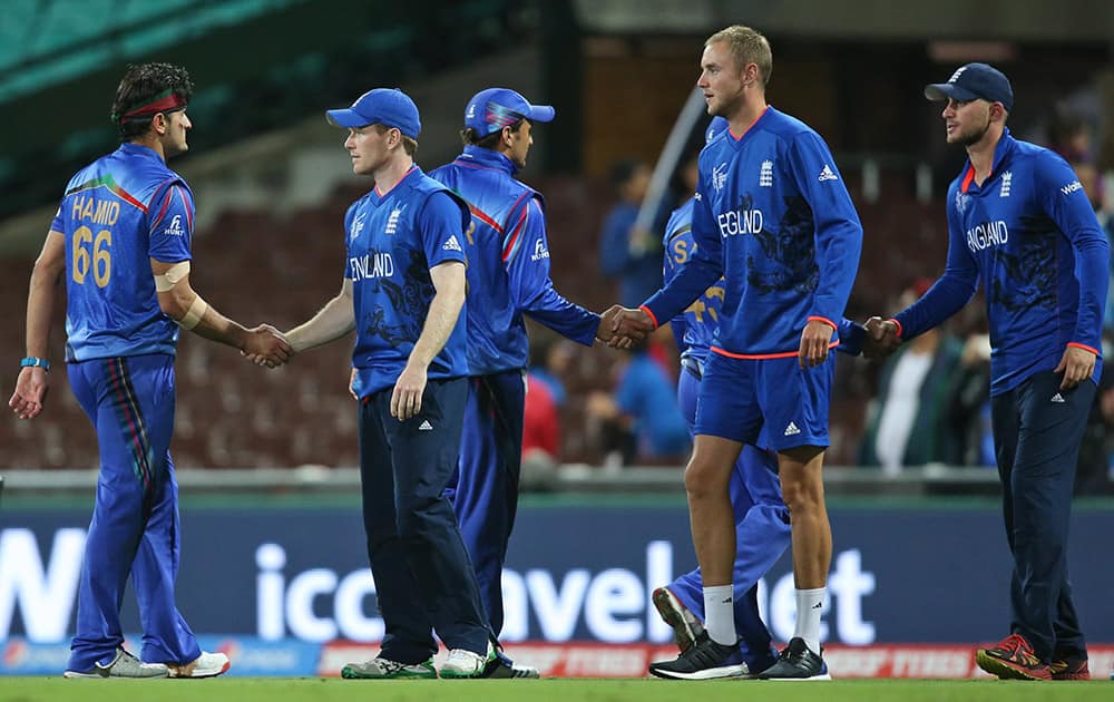 Afghanistan’s Hassan Hamid shakes hand with England’s captain Eoin Morgan, during their Cricket World Cup pool A match in Sydney, Australia.