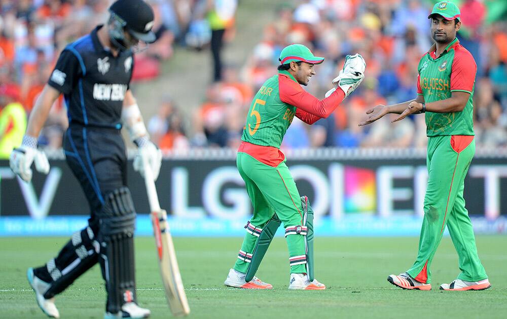 Bangladesh’s Mushfiqur Rahim congratulates teammate Tamim Iqbal after he took the catch to dismiss New Zealand’s Kane Williamson during their Cricket World Cup Pool A match in Hamilton, New Zealand.