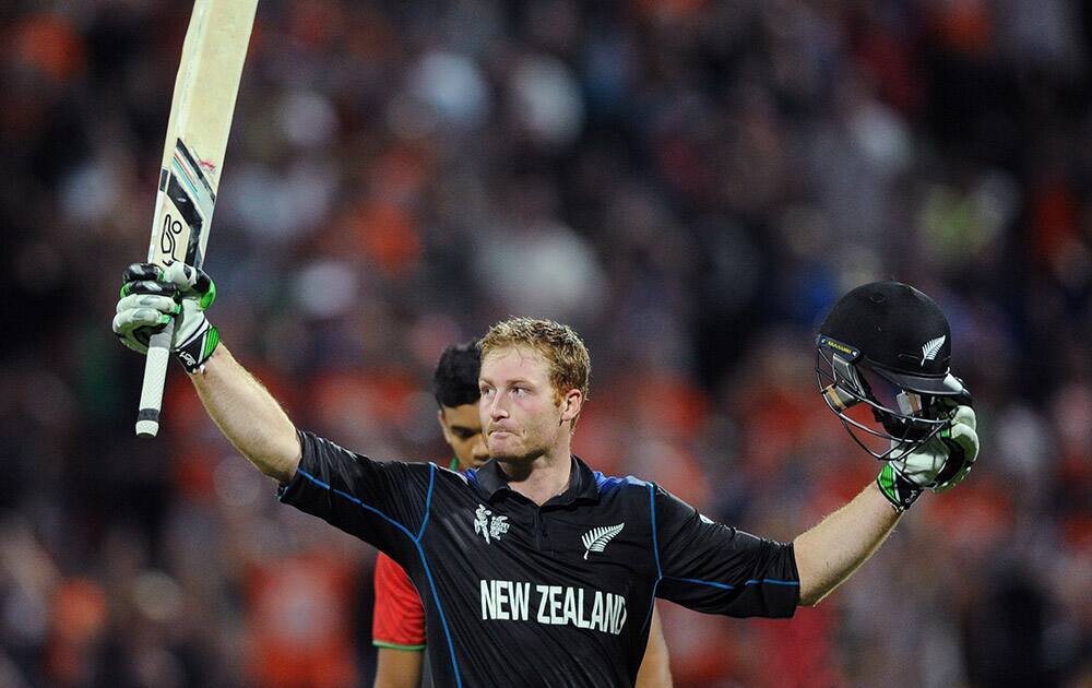 New Zealand’s Martin Guptill waves his bat as he celebrates after scoring a century while batting against Bangladesh during their Cricket World Cup Pool A match in Hamilton, New Zealand.