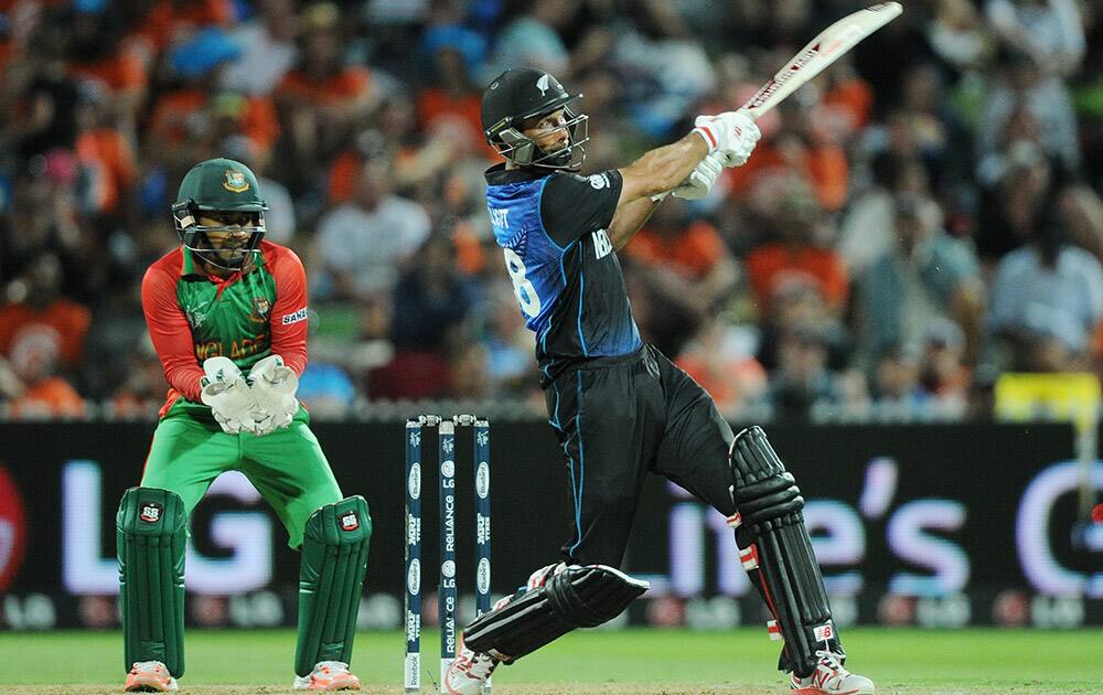 New Zealand’s Grant Elliott hits the ball as Bangladesh wicketkeeper Mushfiqur Rahim watches during their Cricket World Cup Pool A match in Hamilton, New Zealand.