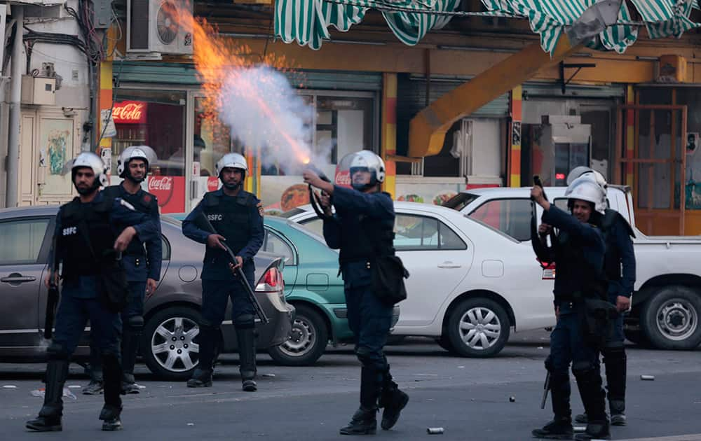 Riot police fire tear gas canisters toward Bahraini anti-government protesters during clashes in Daih, Bahrain.