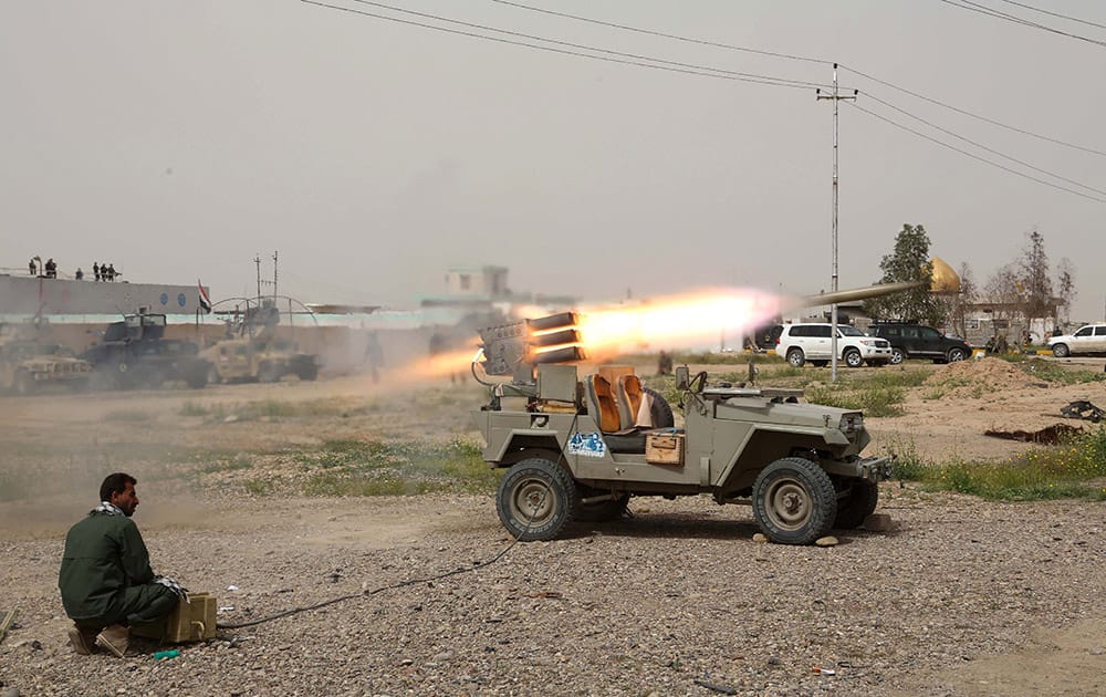 A member of an Iraqi Shiite militant group called Soldiers of Imam Ali Brigades launches rockets against Islamic State extremist positions in Tikrit, 80 miles (130 kilometers) north of Baghdad, Iraq.