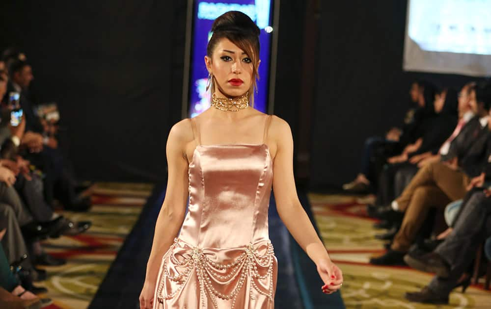 A model displays a dress designed by Iraqi designer Senan Kamil during a fashion show at Baghdad's al-Rasheed Hotel.