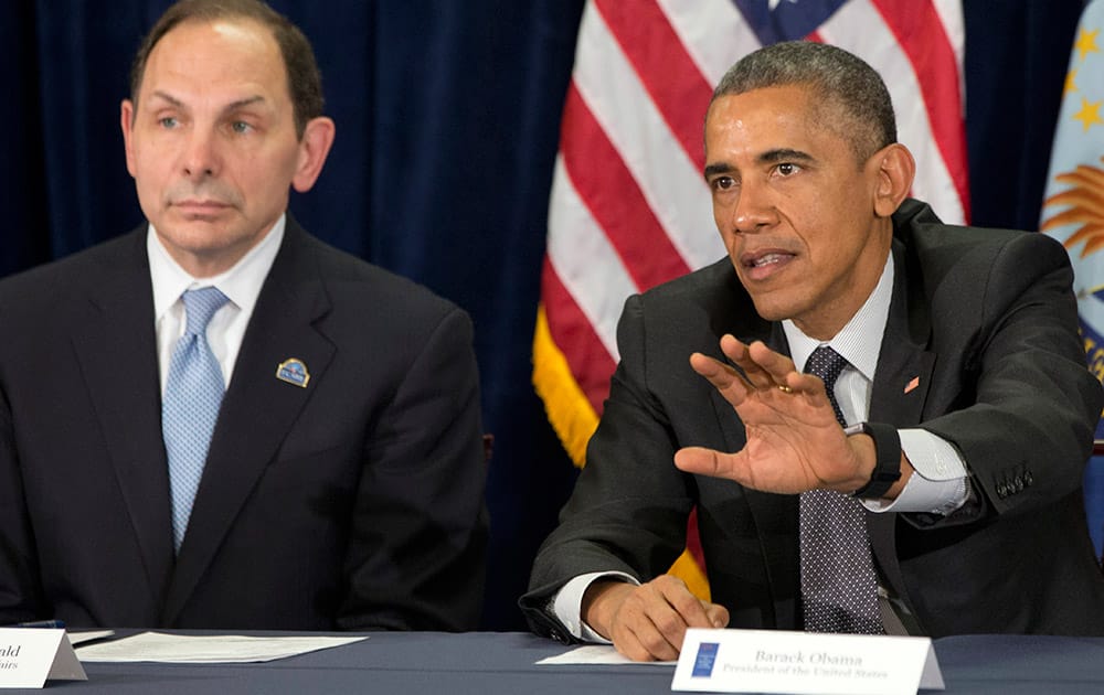 President Barack Obama speaks next to new VA Secretary Robert McDonald during a meeting on veterans issues at the Phoenix VA Medical Center.