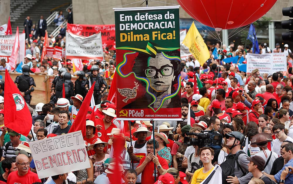 Demonstrators gather for a march in support of the state-run oil company Petrobras and Brazil's President Dilma Rousseff, outside the Petrobras office building, in Sao Paulo, Brazil.