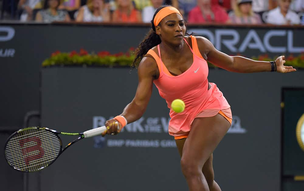 Serena Williams returns to Monica Niculescu, of Romania, in a qualifying tennis match at the BNP Paribas Open tennis tournament.