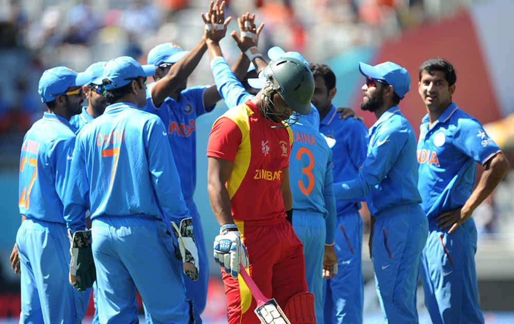 Zimbabwe batsman Chamunorwa Chibhabha walks from the field after he was dismissed by India's Mohammed Shami during their Cricket World Cup Pool B match in Auckland, New Zealand.