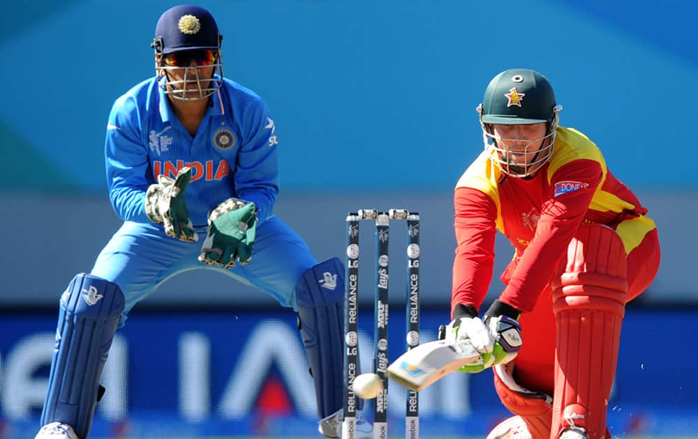 Zimbabwe batsman Brendan Taylor plays a reverse sweep shot as Indian wicketkeeper MS Dhoni watches during their Cricket World Cup Pool B match in Auckland, New Zealand.